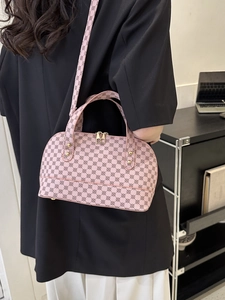 Pink vintage shell-shaped crossbody bag with floral print and gold hardware detail