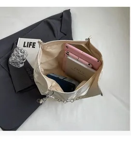 Spacious interior of white canvas tote bag holding tablets, books and accessories
