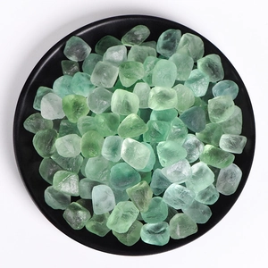 Natural green fluorite raw crystals displayed on a minimalist black round plate