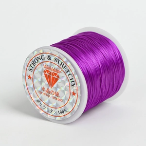 Purple elastic crystal string on a spool for DIY jewelry making and bracelets