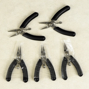 Five-piece jewelry tool set with black anti-slip pliers and springs for DIY jewelry making