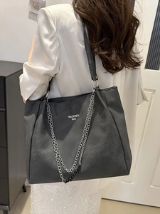 Minimalist large black tote bag with double straps and decorative silver chain detail