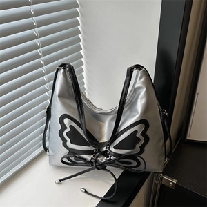 Silver metallic bucket bag with black butterfly patch and lace-up detail for women