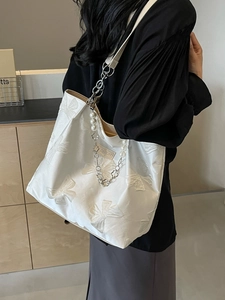 White canvas tote bag with bow jacquard pattern and pearl chain strap for women