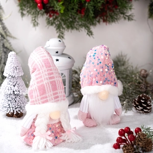 Detail of pink sequin Christmas gnomes with knit hats in a festive winter snow scene