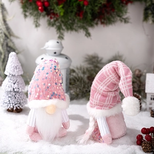 Pink Christmas gnomes with sequins and knits on a snowy festive background