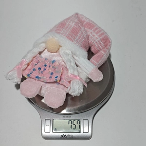 Pink Christmas gnome plush weight measurement showing 75.7g on a digital scale