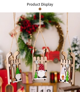 Three wooden Christmas gnome ornaments on sleds with trees and rustic twine strings