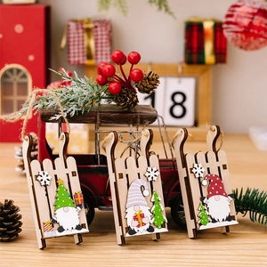 Detailed view of three wooden Christmas gnome sled pendants with rustic twine hangers