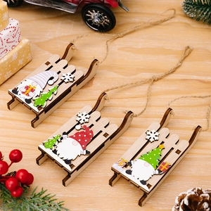 Detailed view of three festive wooden Christmas sled ornaments with gnome designs