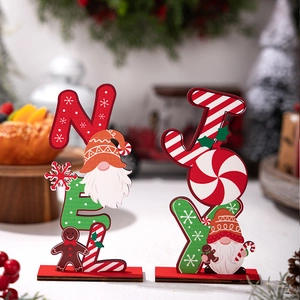 Detailed view of NOEL and JOY Christmas wooden signs with gingerbread man and gnome