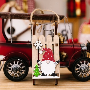 Detailed view of a wooden Christmas gnome ornament with red hat and rustic jute string