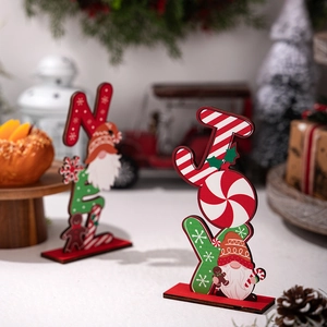 Detail of NOEL and JOY wooden Christmas ornaments with gingerbread and gnome figures