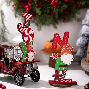 Detail of wooden JOY and NOEL Christmas tabletop ornaments with gingerbread man and gnome