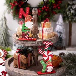 Detail view of Noel and Joy Christmas wooden signs on a rustic tiered tray display