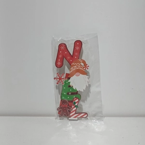 Close-up of wooden NOEL letter sign with Christmas gnome and gingerbread man ornaments