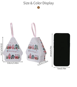 Christmas tin box in house shape with pink ribbon and size comparison next to a phone