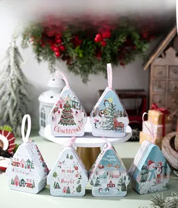 Close-up of triangular Christmas tin boxes with silk ribbons and festive illustrations