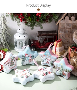 Detail of star-shaped Christmas tin boxes with festive illustrations and hanging ribbons