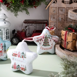 Star-shaped Christmas tin box with hanging rope and festive holiday tree illustrations