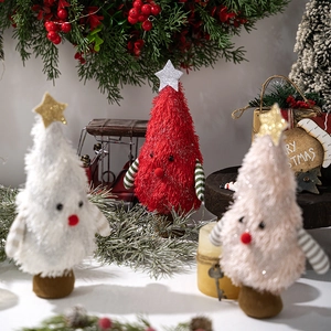 Close-up of plush Christmas tree ornaments with fuzzy texture and cute faces