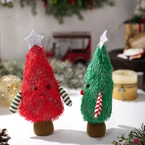 Close-up of red and green plush Christmas tree dolls with festive stars and striped arms