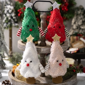 Detail of four colorful plush Christmas tree ornaments on a wooden display tray