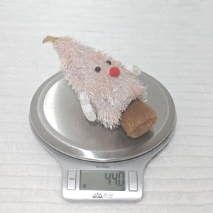 Weight display of pink plush Christmas tree doll showing 44.0g on a digital scale