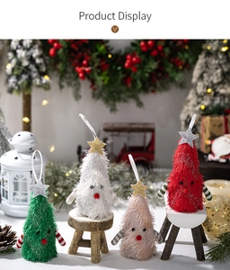 Close-up of four colorful plush Christmas tree ornaments with glowing star tops