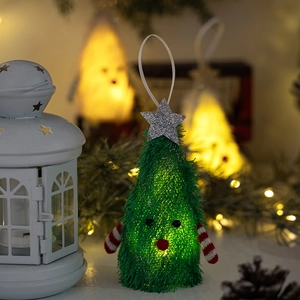 Detail of a glowing plush Christmas tree ornament with warm LED light and striped arms