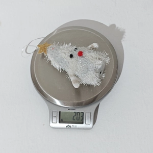 Macro shot of fluffy white Christmas tree plush pendant with gold star and LED feature
