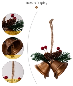 Detail view of rustic Christmas bell ornament with pine cones, berries and hemp rope