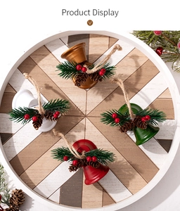 Detail of Christmas bell ornaments with pine branches, berries and pinecones in four colors