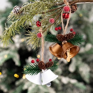 Close-up of rustic Christmas bell ornaments with pine cones and berries on a tree