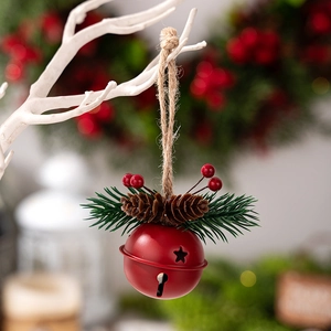 Detail of red frosted Christmas bell with pine cones, needles and berries on twine