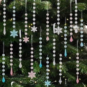 Close-up of acrylic Christmas snowflake and icicle ornaments on a festive pine tree