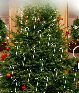Sparkling acrylic Christmas candy cane ornaments with sequins on a decorated tree
