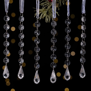 Close-up of clear acrylic icicle ornaments with faceted beads for Christmas tree decor