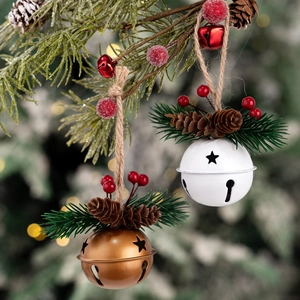 Christmas hanging bells with pine cones and red berries on a rustic rope decoration