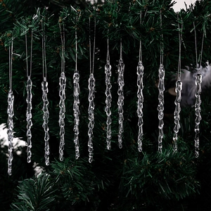 Detailed view of 12 transparent acrylic icicle ornaments hanging on a green Christmas tree