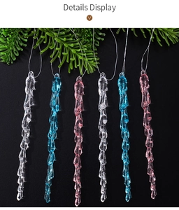 Macro detail of acrylic icicle Christmas ornaments in transparent, blue and pink colors