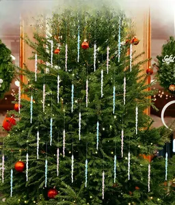 Detailed view of spiral acrylic icicle ornaments in blue, pink, and clear on a tree