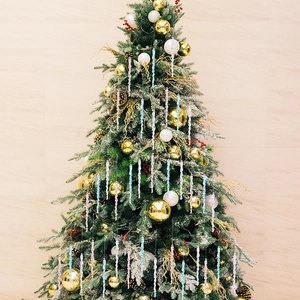 Macro detail of spiral acrylic icicle ornaments in pastel colors on a Christmas tree