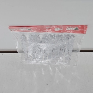 Close-up of clear acrylic icicle ornaments in Christmas themed plastic packaging