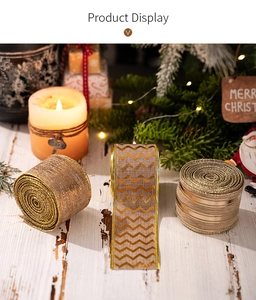 Close-up of Christmas linen ribbons with golden wave patterns and festive decor