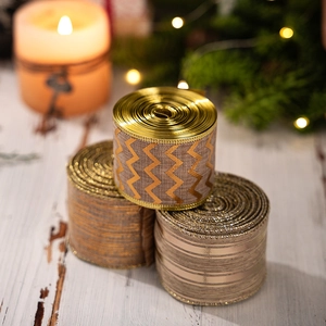 Detailed view of festive metallic ribbons with wavy textures for Christmas tree decoration