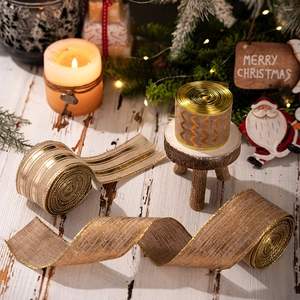 Close-up of golden linen Christmas ribbons with wave patterns for tree decoration