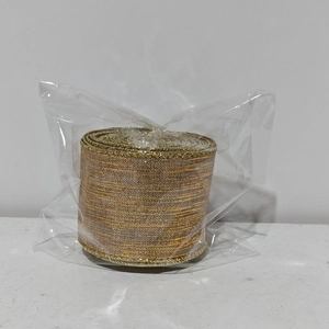 Detailed view of champagne gold glitter ribbon roll for Christmas wreath decoration