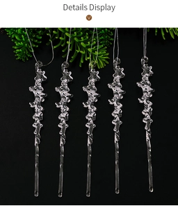 Detailed view of five transparent acrylic icicle ornaments hanging with white strings