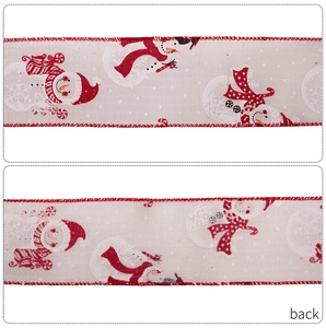 Detailed macro view showing the snowman print and linen texture on Christmas ribbon